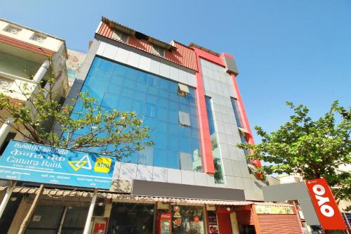 a tall building with a sign in front of it at Hotel O India Gate in Chennai