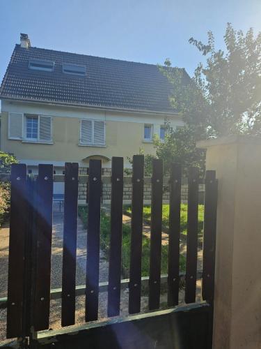a black fence in front of a house at Maison Ethno Chic proche de Paris et d'Orly in Morangis