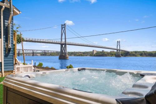 a hot tub with a view of a bridge at Hudson Escape W Hot Tub Bridge View in Highland
