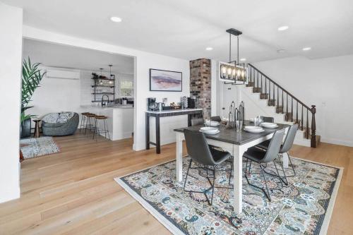 a dining room and living room with a table and chairs at Hudson Escape W Hot Tub Bridge View in Highland