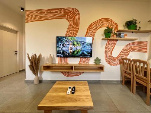 a living room with a tv on a wall at Nomads Hostel in Dahab
