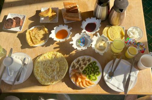 a table with a bunch of different types of breakfast foods at Riad Fez Medina in Fès