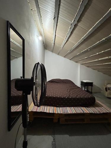 a bed in a room with a mirror at Ninho da Cegonha Assumar in Assumar