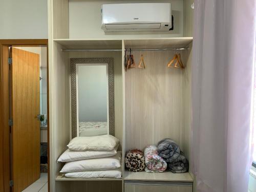a bathroom with a mirror and a pile of towels at Golden Dolphin Supreme in Caldas Novas