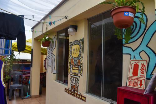 a restaurant with a pot on the side of a building at Passion Hostel - Barranco in Lima