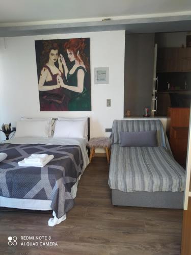 a bedroom with a bed and a painting on the wall at Evelina's House in Tolo