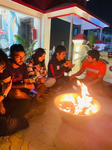 a group of people sitting around a fire pit at The Commune Banaras in Varanasi