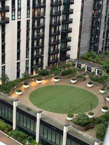 a garden in front of a large building at Luxury 2Bed 2 bath with free Parking NEAR WEMBLEY STADIUM Book Now in London