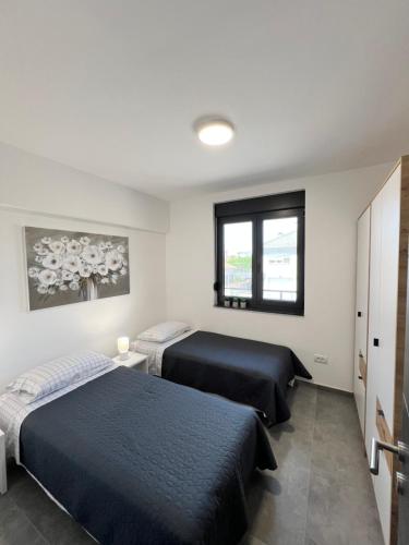 Ένα ή περισσότερα κρεβάτια σε δωμάτιο στο DC Executive Apartments