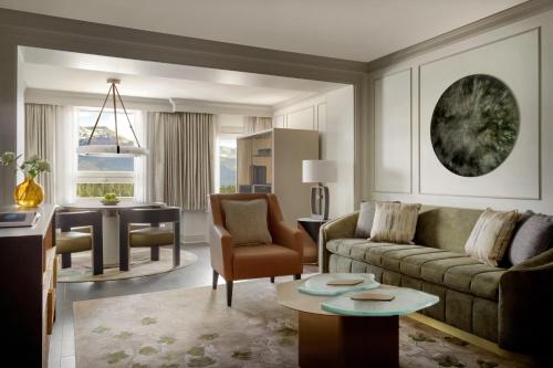 a living room with a couch and a table at Fairmont Château Lake Louise in Lake Louise