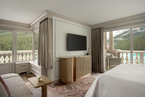 a hotel room with a bed and a television at Fairmont Château Lake Louise in Lake Louise
