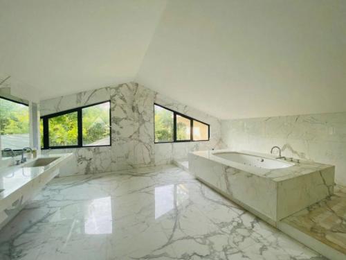 a large white bathroom with two sinks and a tub at B&B Family Villa perfectly located in Rome