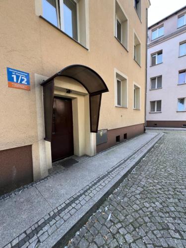 a building with a door on the side of it at Apartament EROS II in Bolesławiec