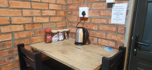 a wooden table with condiments on top of a brick wall at LyonsDen 2 in Worcester