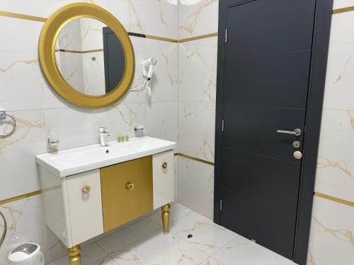 a bathroom with a sink and a mirror at Golden Hill Palace in Novi Pazar