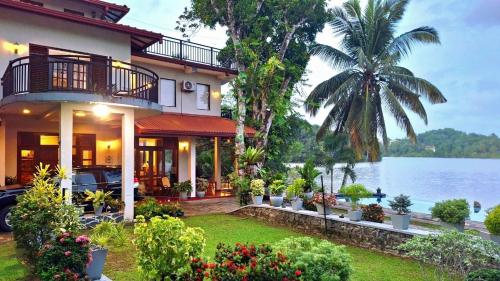 a house with a view of the water at MYH - Lake Front Pvt Villa with Staff and Includes FREE Breakfast of your choice in Bandaragama