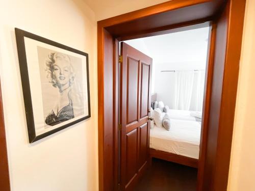 a hallway with a picture of a woman and a bedroom at LOS CORALES Resort VILLAS & Apartments WIFI BEACH Club & SPA in Punta Cana