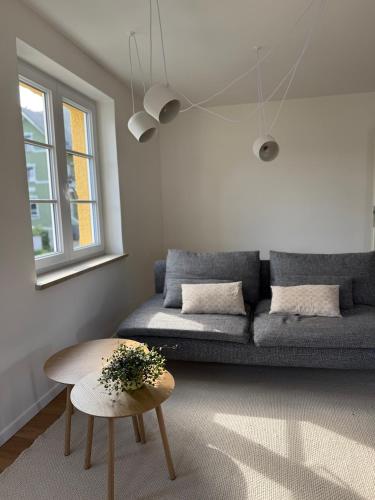 a living room with a couch and a table at Villa19hundert5 moderne Ferienwohnungen in zentraler Lage in Lindenberg im Allgäu