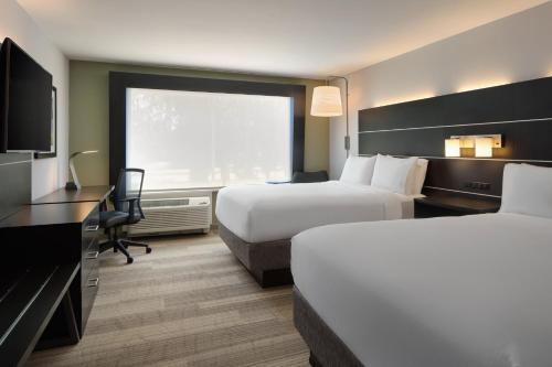 a hotel room with two beds and a television at Holiday Inn Express & Suites Brunswick by IHG in Brunswick