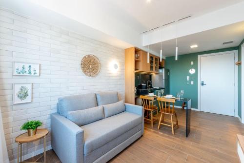 a living room with a couch and a kitchen at GO Rio Branco by LikeHome in Porto Alegre