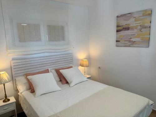 a white bed with two pillows in a bedroom at Apartamento Paraíso del Sol in Benajarafe