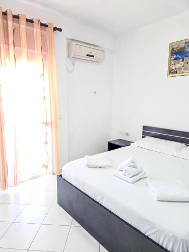 a bedroom with a bed and a window at Hotel Azure in Dhërmi