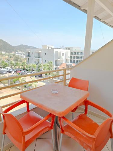 a table and two chairs on a balcony at Hotel Azure in Dhërmi