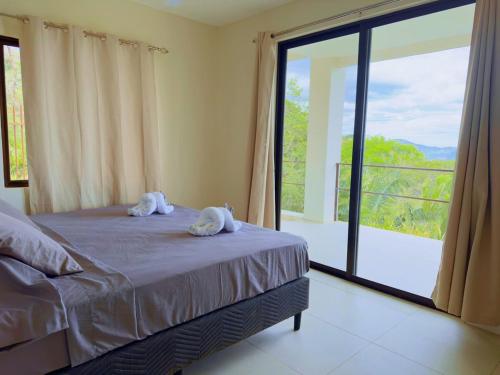 Una cama o camas en una habitación de Casa Flores Ocean view 10 min to Carrillo
