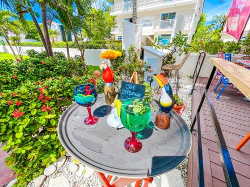 a table with three wine glasses on a patio at LOS CORALES Resort VILLAS & Apartments WIFI BEACH Club & SPA in Punta Cana