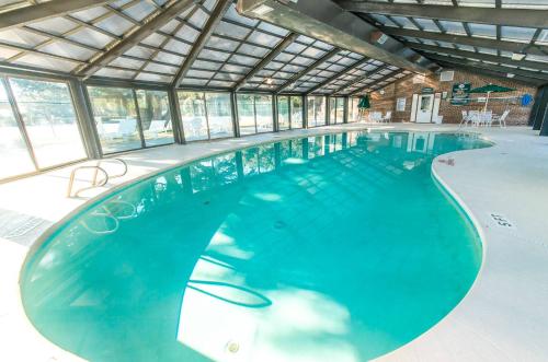 a large swimming pool in a building with windows at Sounds Great! in Duck