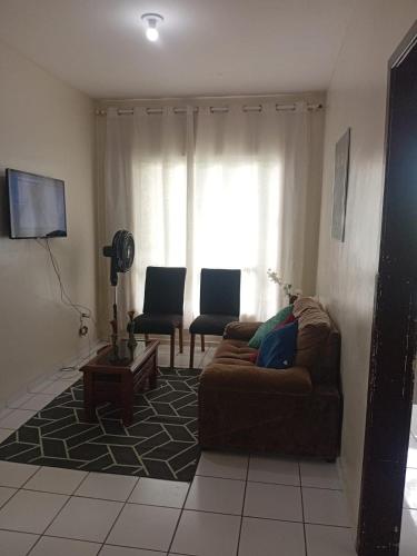 a living room with a couch and a window at Apartamento com Wi-Fi e lazer completo in Ananindeua