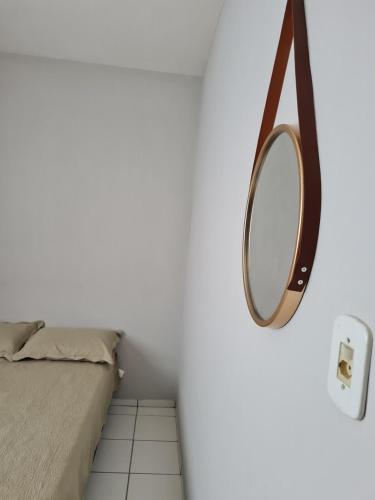 a bedroom with a bed and a mirror on the wall at Apartamento com Wi-Fi e lazer completo in Ananindeua