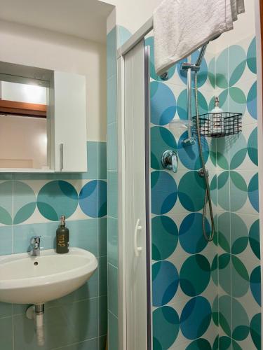 a bathroom with a sink and a shower at TiTò Apartment in Naples