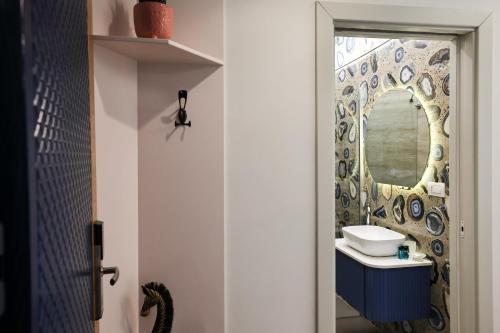 a bathroom with a sink and a mirror at The MONT BOUTIQUE HOTEL in Shkodër