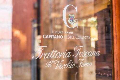 a sign in a window of a hotel at PALAZZO DEL CAPITANO Wellness & Relais - Luxury Borgo Capitano Collection in San Quirico dʼOrcia