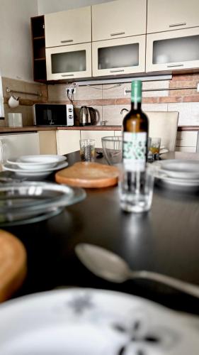a bottle of wine sitting on top of a table at Retro Lakefront House With A Dock in Balatonvilágos