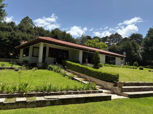 a house with a garden in front of it at Villa San Marcos in San Cristóbal de Las Casas