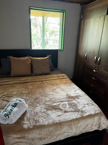 a bedroom with a bed with a dresser and a window at Eco Hotel Rancho J en Tulua Valle in Morales
