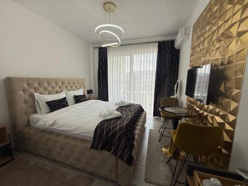 a bedroom with a large bed and a table and chairs at Golden Hill Palace in Novi Pazar
