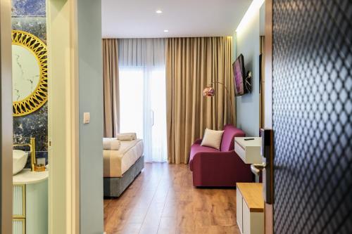 a living room with a couch and a bed in a room at The MONT BOUTIQUE HOTEL in Shkodër