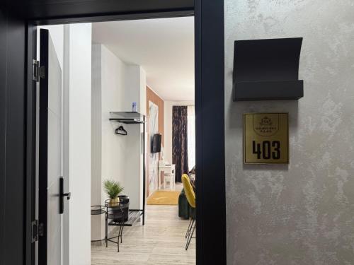 a hallway with a door open to a living room at Golden Hill Palace in Novi Pazar