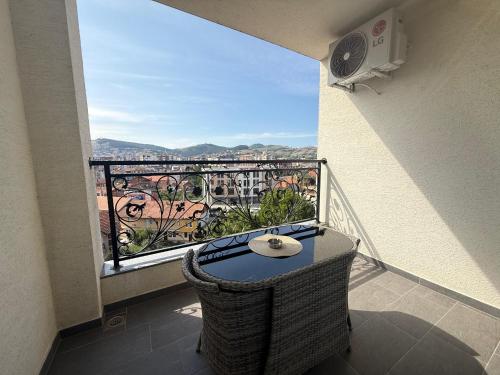 a balcony with a table and a view of a city at Golden Hill Palace in Novi Pazar