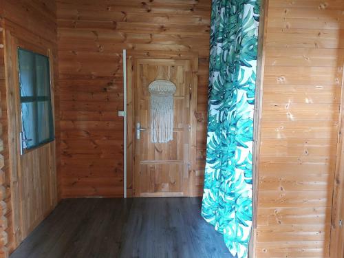 a room with a wooden door with a window at Pause nature au cœur des forêts in Saint-Pal-de-Senouire