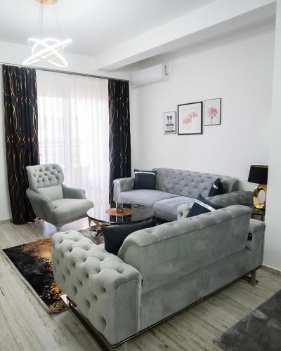 a living room with couches and a couch and a table at Golden Hill Palace in Novi Pazar