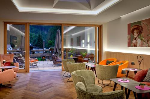 a restaurant with tables and chairs and a patio at Der Waldhof - Unique - A hidden gem in Sankt Anton am Arlberg