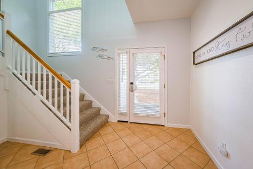 a staircase in a home with white walls at Currituck Carl's in Sanderling