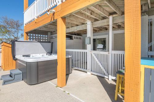 a barbecue grill on the back of a house at Follow the Sun in Duck
