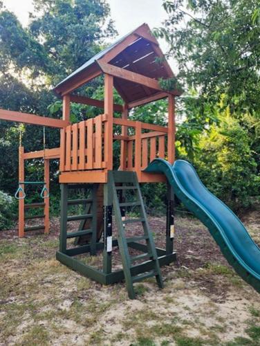 a playground with a slide and a play structure at Follow the Sun in Duck