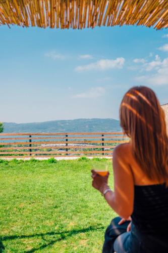 a woman sitting on the grass looking at a field at tetova in Sapanca