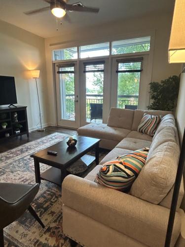 a living room with a couch and a coffee table at 2 Bedroom Boutique Apartment in the Heart of Charlotte in Charlotte